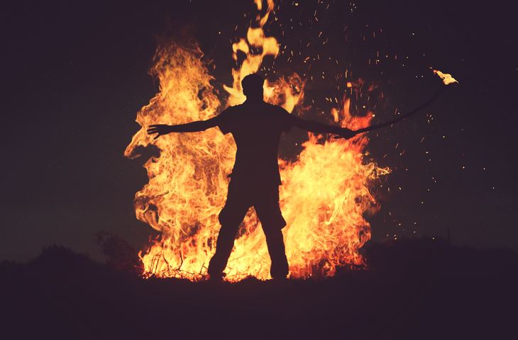 Person standing in front of fire